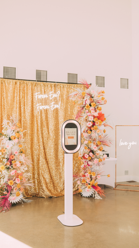 NWA Photo Booth is surrounded by a floral instal from Darling Blooms in Northwest Arkansas